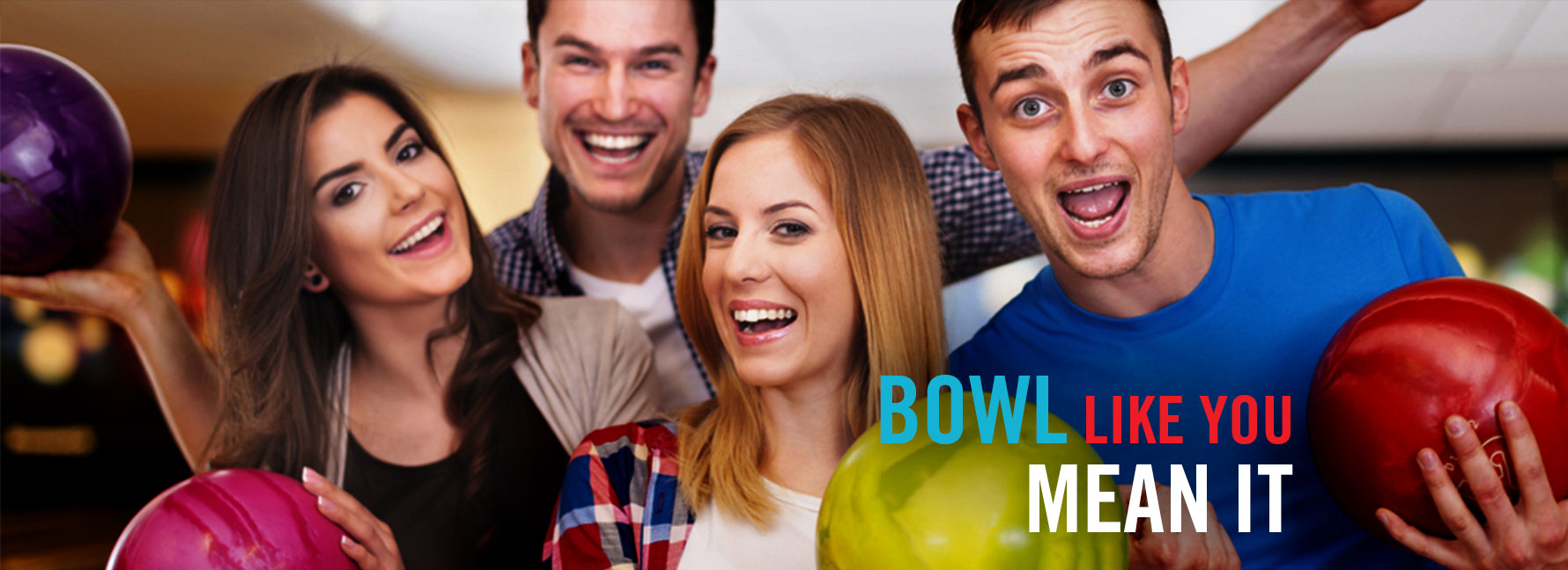 Four people holding bowling balls and smiling